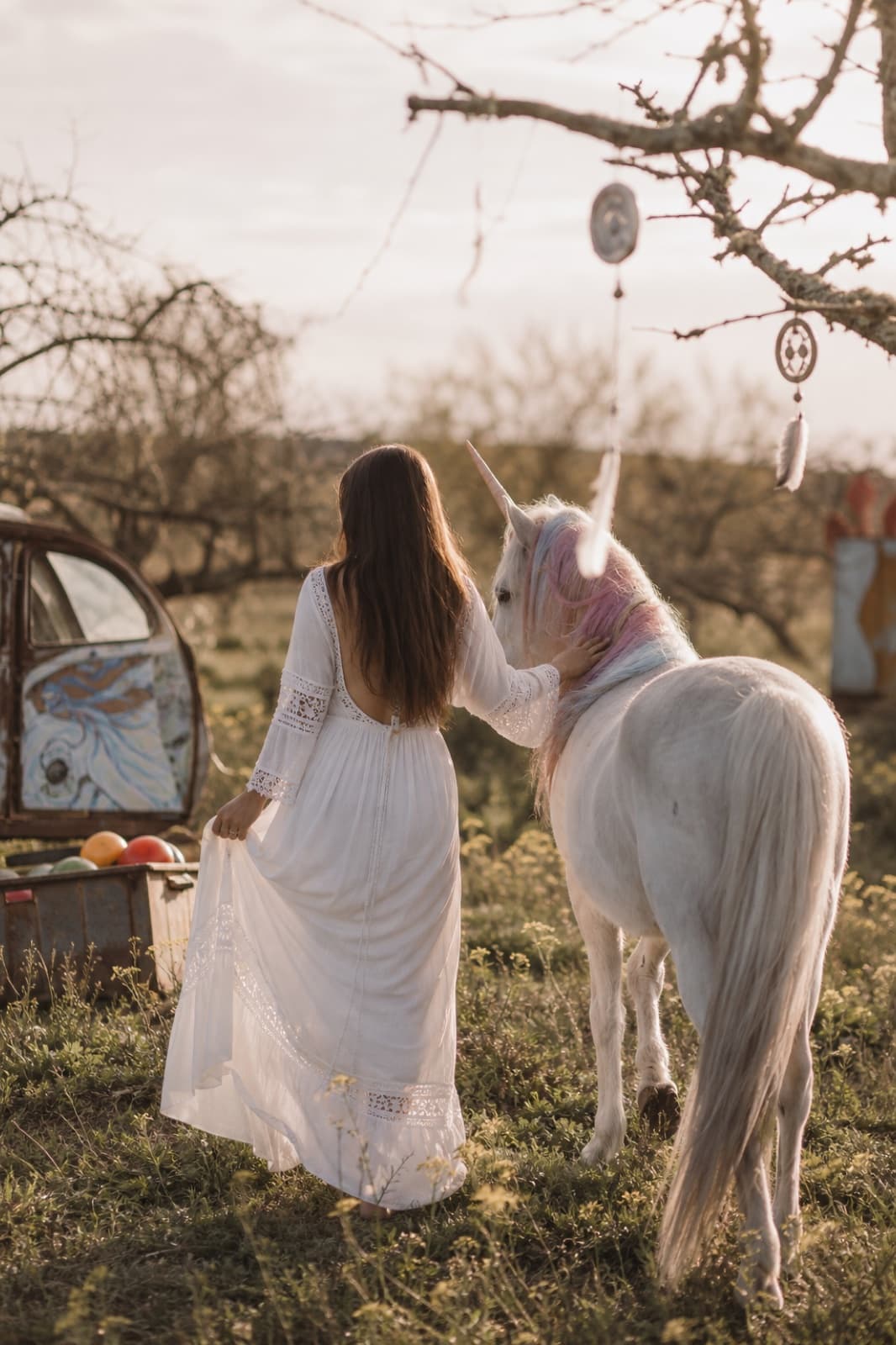 Woman with unicorn in golden hour light